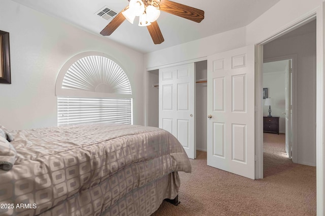 bedroom with carpet, visible vents, a closet, and ceiling fan