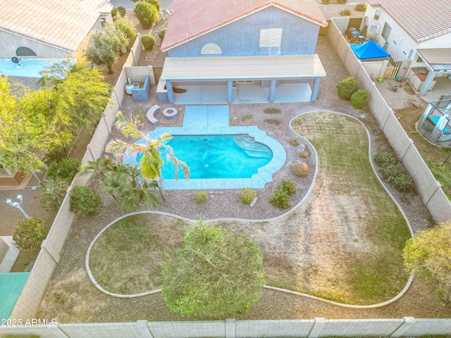 community pool featuring a patio area and a fenced backyard