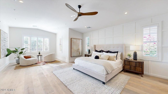 bedroom with ceiling fan, light hardwood / wood-style floors, and lofted ceiling