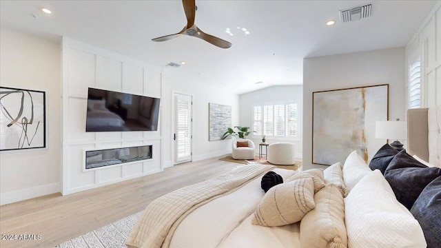 bedroom featuring ceiling fan, light hardwood / wood-style flooring, and vaulted ceiling