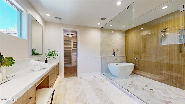 bathroom featuring vanity and plus walk in shower