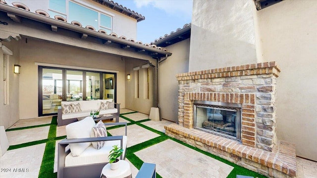 view of patio / terrace featuring an outdoor living space with a fireplace