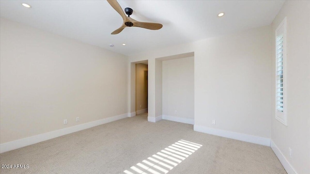 carpeted empty room featuring ceiling fan