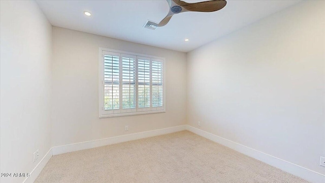 unfurnished room with light carpet and ceiling fan