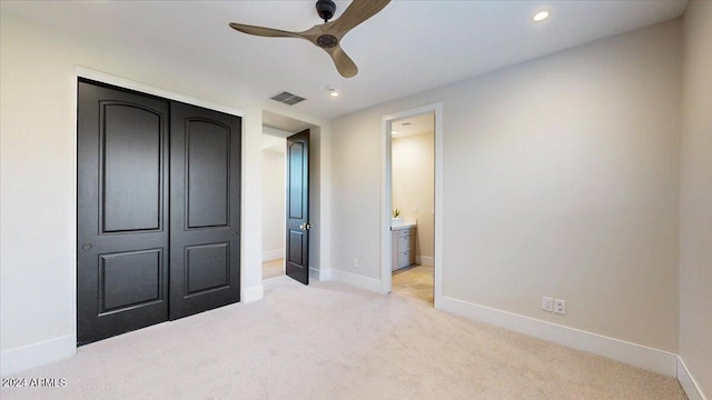 unfurnished bedroom with light carpet, a closet, and ceiling fan