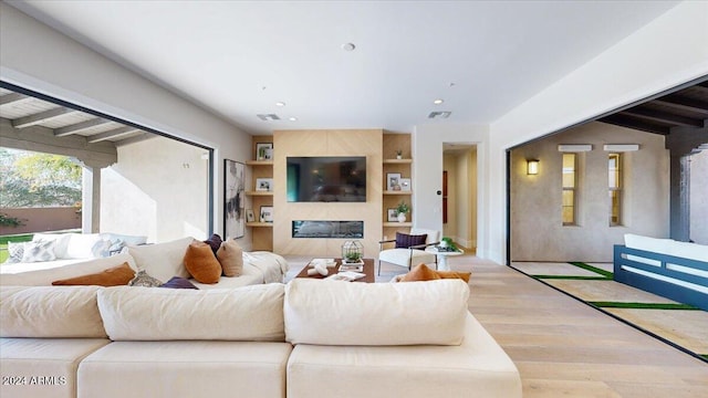 living room featuring hardwood / wood-style floors and beamed ceiling