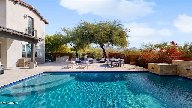 view of swimming pool with a patio