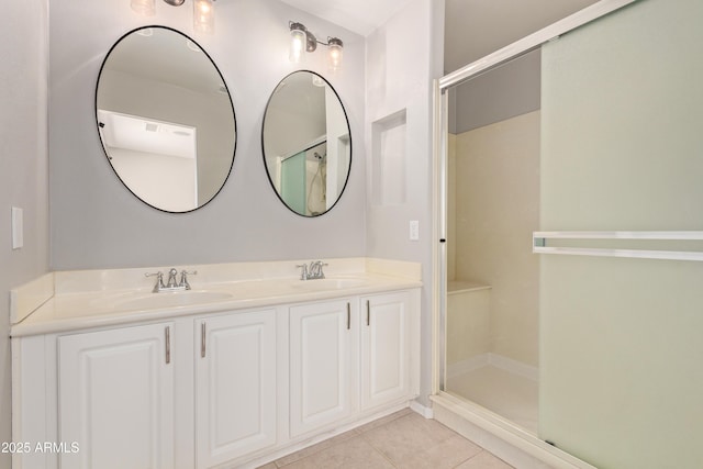 bathroom featuring tile patterned flooring, vanity, and walk in shower