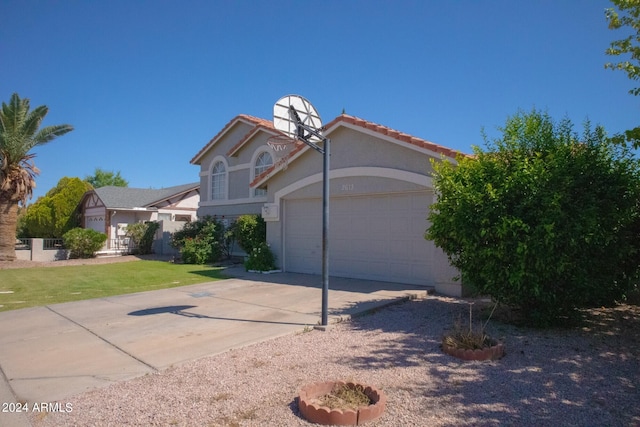 view of front of home with a front yard and a garage