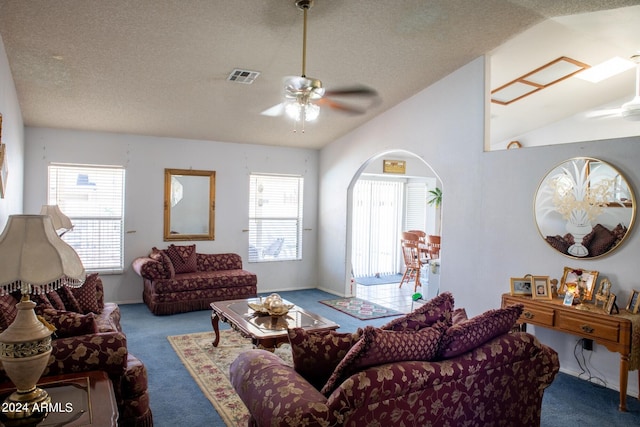 living room with carpet, a wealth of natural light, ceiling fan, and vaulted ceiling