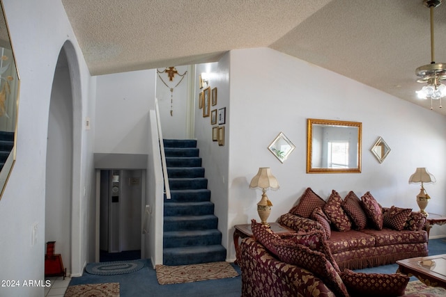 living room featuring vaulted ceiling and ceiling fan