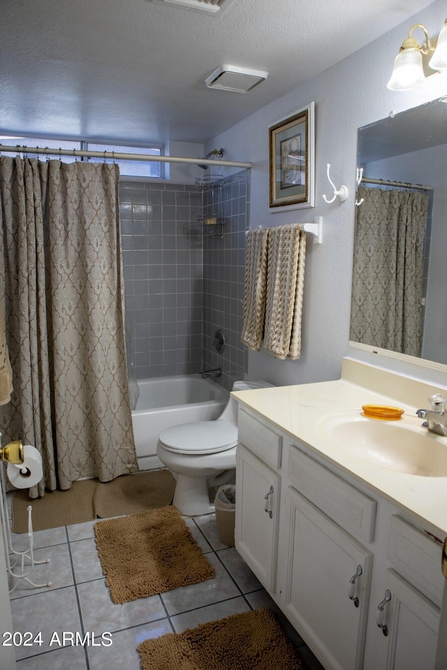 full bathroom with vanity, a textured ceiling, shower / bathtub combination with curtain, tile patterned flooring, and toilet