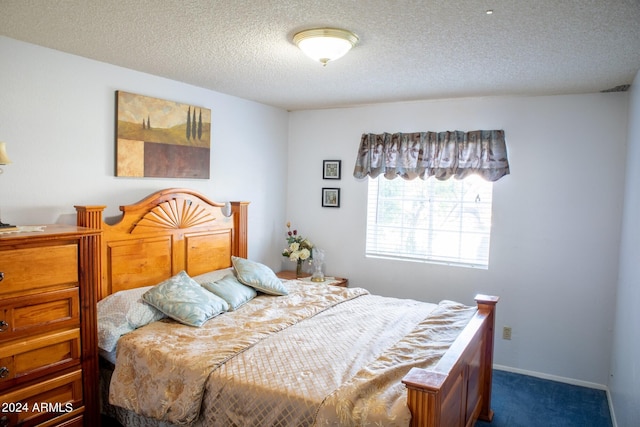 carpeted bedroom featuring a textured ceiling