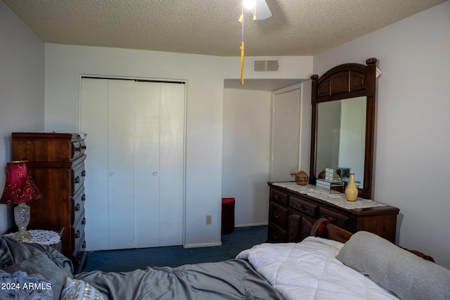 carpeted bedroom with a textured ceiling, a closet, and ceiling fan