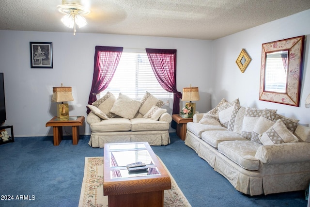 living room featuring carpet flooring, ceiling fan, and a textured ceiling