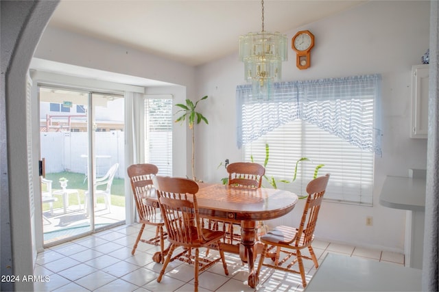 tiled dining room with a wealth of natural light and a notable chandelier