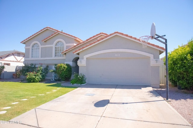 mediterranean / spanish-style house featuring a garage and a front yard