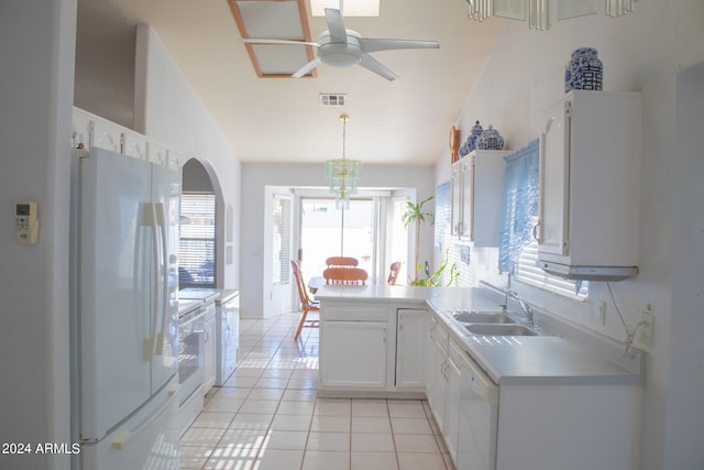 kitchen featuring pendant lighting, white appliances, white cabinets, sink, and light tile patterned floors