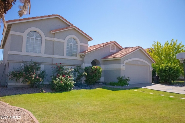 mediterranean / spanish-style house with a front yard and a garage