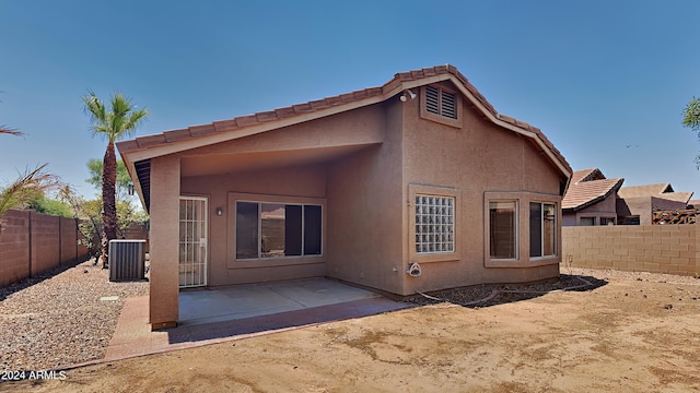 rear view of house with a patio and central AC unit