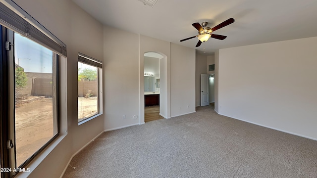 carpeted spare room with ceiling fan