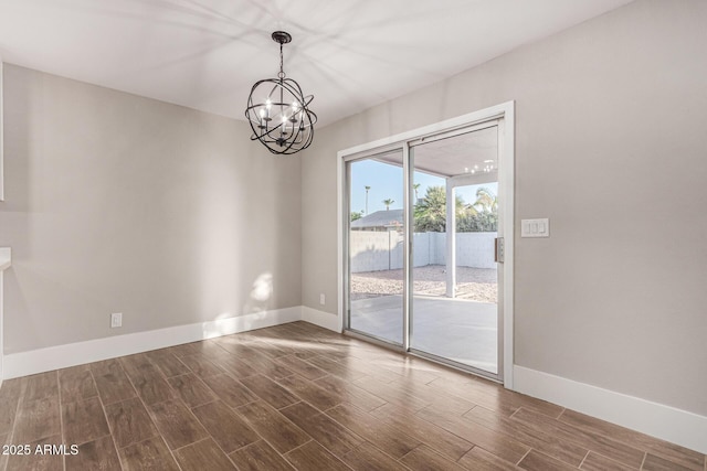 unfurnished room featuring an inviting chandelier