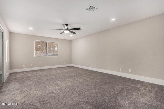 carpeted empty room with a wealth of natural light and ceiling fan