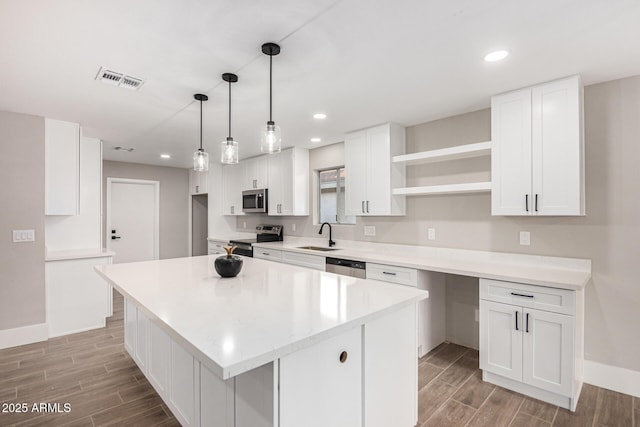 kitchen with white cabinetry, a kitchen island, and stainless steel appliances