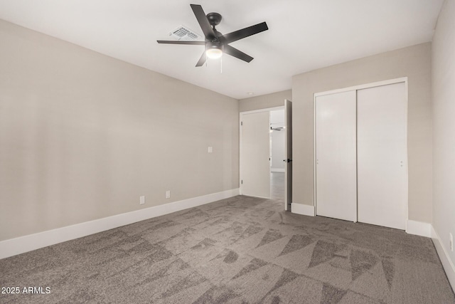 unfurnished bedroom with carpet flooring, ceiling fan, and a closet