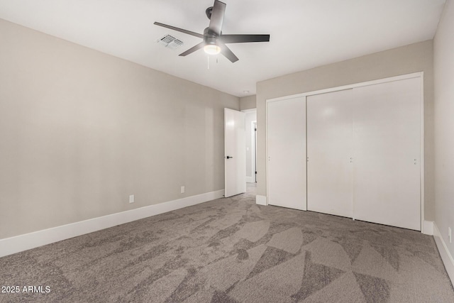 unfurnished bedroom with ceiling fan, carpet floors, and a closet