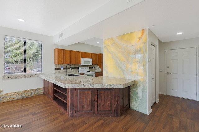 kitchen featuring kitchen peninsula, decorative backsplash, dark hardwood / wood-style flooring, white appliances, and sink