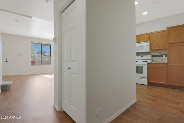 hallway with hardwood / wood-style floors