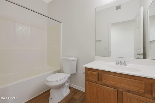 full bathroom featuring hardwood / wood-style floors, vanity, toilet, and tub / shower combination