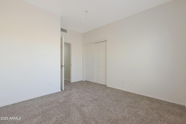 unfurnished bedroom with carpet flooring and a closet