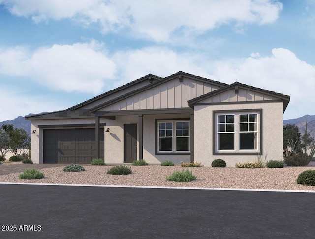 view of front facade featuring driveway, stucco siding, a garage, board and batten siding, and a mountain view