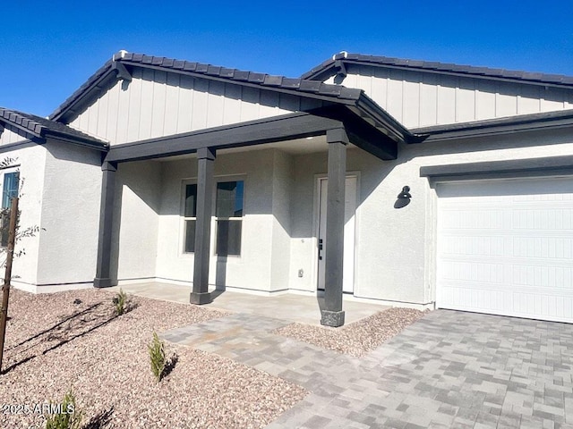 exterior space with a garage and stucco siding