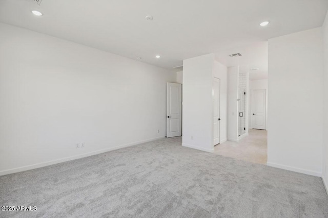 unfurnished room featuring recessed lighting, visible vents, light colored carpet, and baseboards