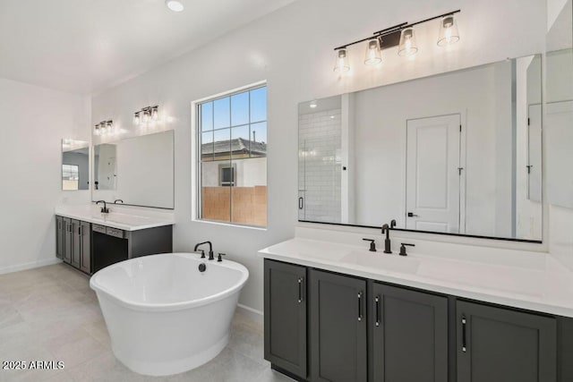 full bath featuring a freestanding bath, two vanities, a stall shower, and a sink