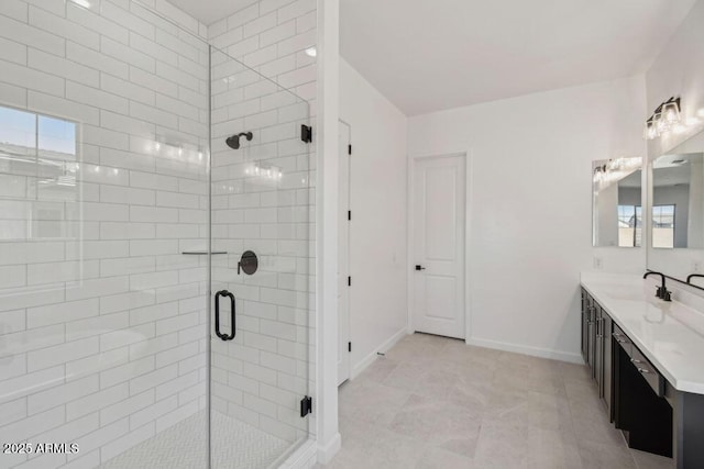 bathroom with baseboards, vanity, and a shower stall