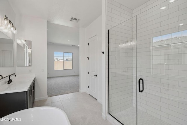 full bathroom with tile patterned floors, visible vents, a shower stall, a soaking tub, and vanity