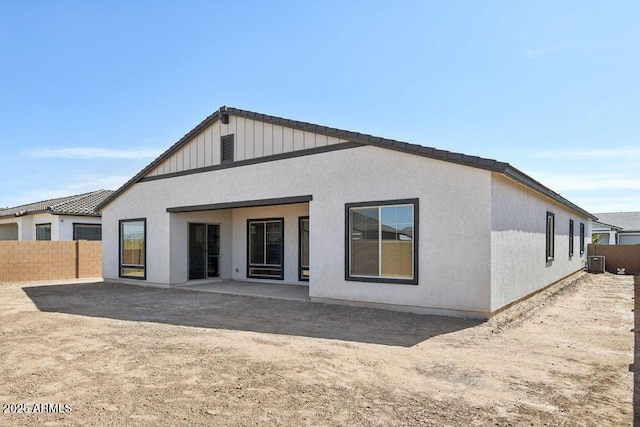 rear view of house featuring a patio area, stucco siding, cooling unit, and fence