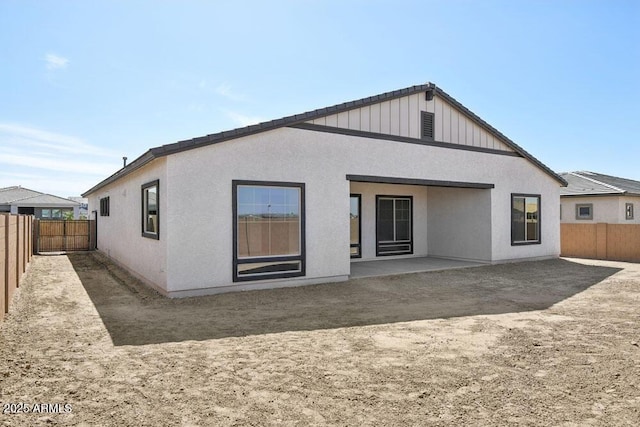 back of property with stucco siding, a patio, and a fenced backyard