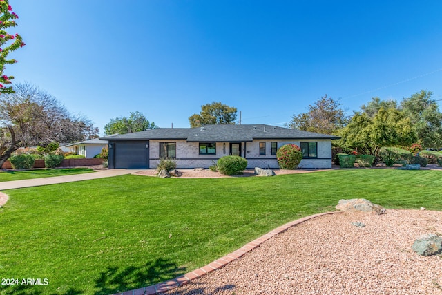 single story home with a front yard and a garage