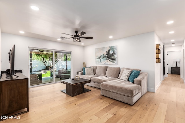 living room featuring light wood-type flooring and ceiling fan