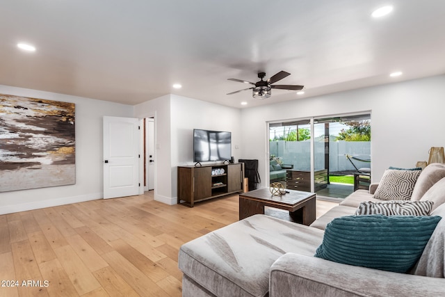 living room with ceiling fan and light hardwood / wood-style floors