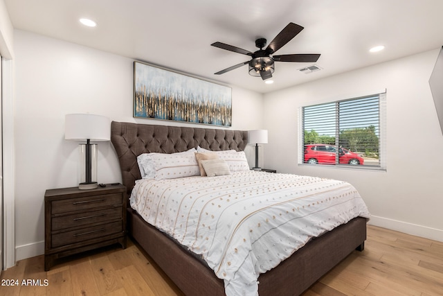 bedroom with ceiling fan and light hardwood / wood-style flooring