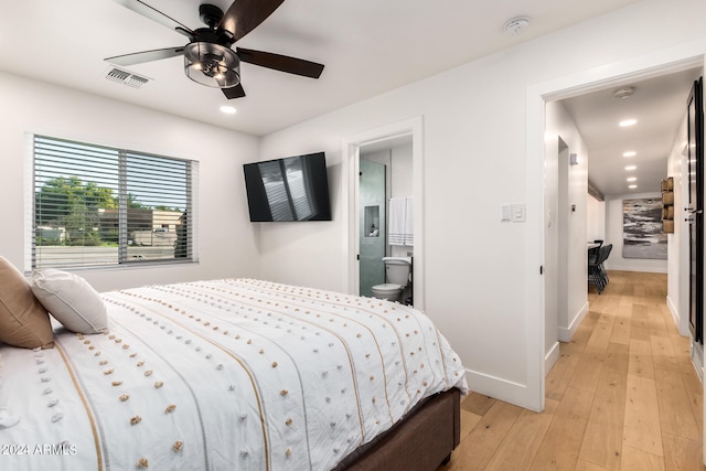 bedroom with light hardwood / wood-style flooring, connected bathroom, and ceiling fan