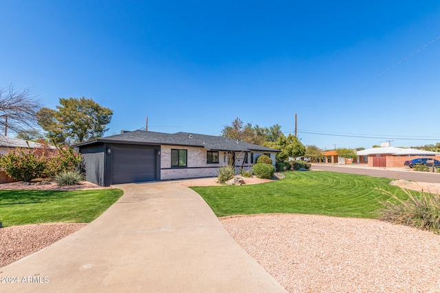 view of front of home featuring a garage and a front yard