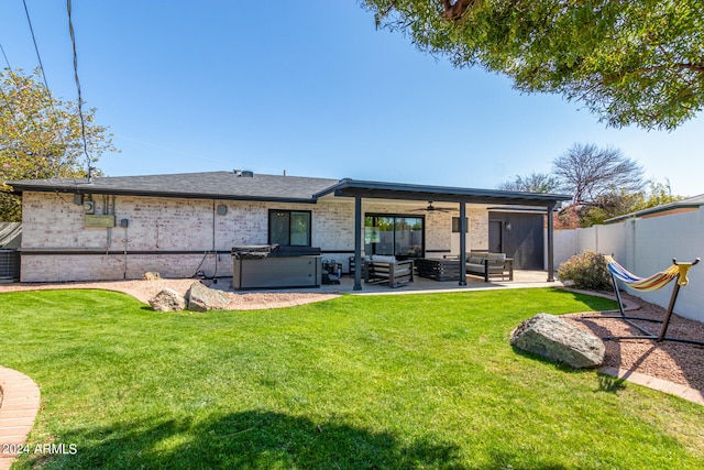 rear view of property with an outdoor hangout area, a patio, and a lawn