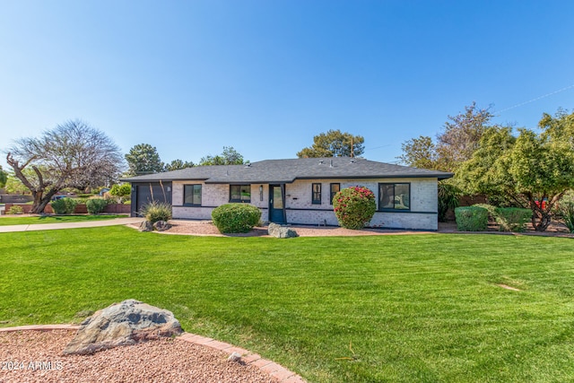 ranch-style home with a sunroom and a front yard